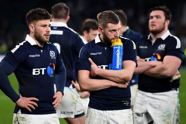 Ali Price, left, and Finn Russell look dejected after Scotlands heavy defeat at Twickenham. Picture: Getty.
