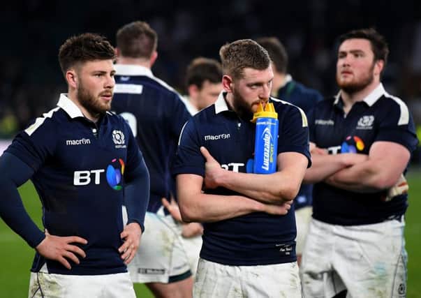 Ali Price, left, and Finn Russell look dejected after Scotlands heavy defeat at Twickenham. Picture: Getty.