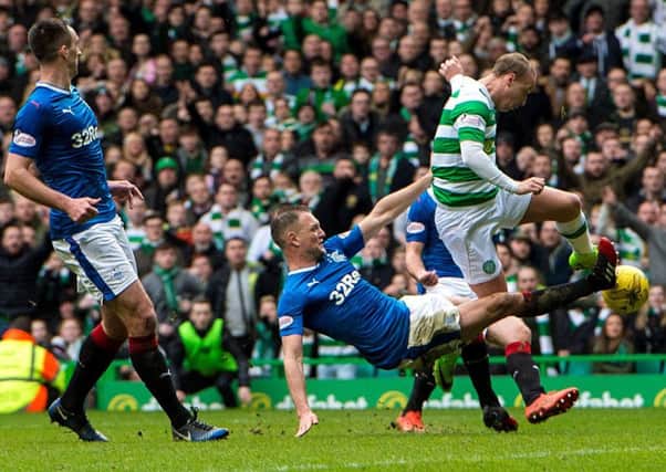 Clint Hill challenges Leigh Griffiths. Picture: SNS/Ross Parker