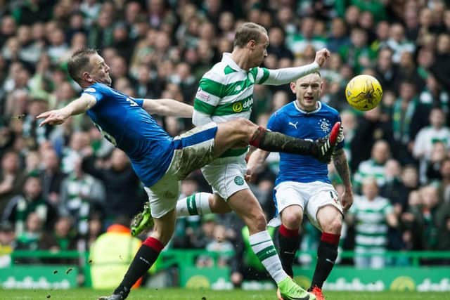 Leigh Griffiths goes down under a challenge from Clint Hill. Picture: John Devlin