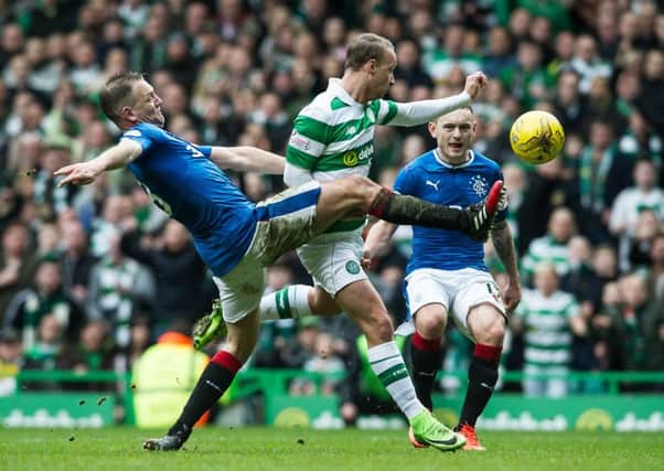 Leigh Griffiths goes down under a challenge from Clint Hill. Picture: John Devlin