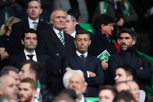 New Rangers manager Pedro Caixinha, along with his agent (right), watches from the stands as Rangers draw with Celtic in the Ladbrokes Premiership. Picture: PA