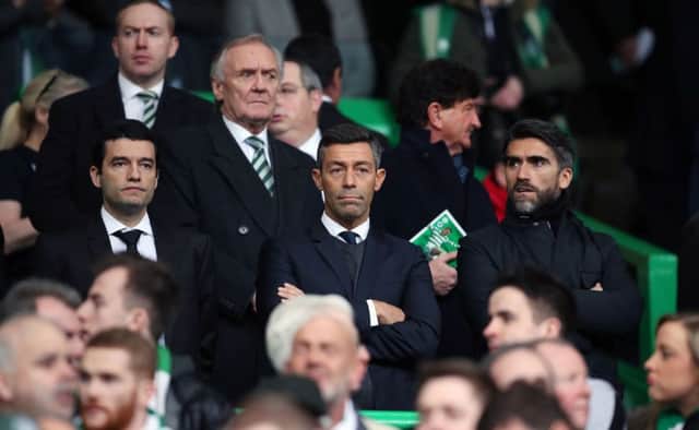 New Rangers manager Pedro Caixinha, along with his agent (right), watches from the stands as Rangers draw with Celtic in the Ladbrokes Premiership. Picture: PA