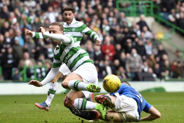 Celtic's players appeal for a penalty as Leigh Griffiths (left) is tackled by Rangers' Clint Hill in the last minute. Picture: SNS