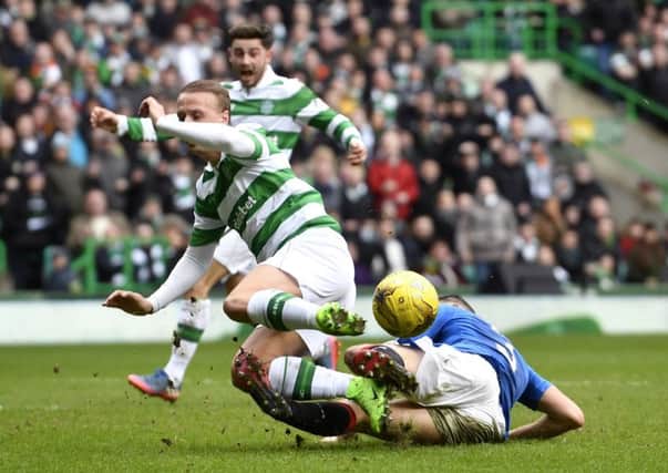 Celtic's players appeal for a penalty as Leigh Griffiths (left) is tackled by Rangers' Clint Hill in the last minute. Picture: SNS