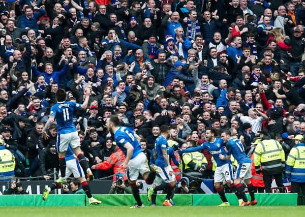 Rangers players and fans celebrate after Clint Hill's late leveller. Picture: John Devlin