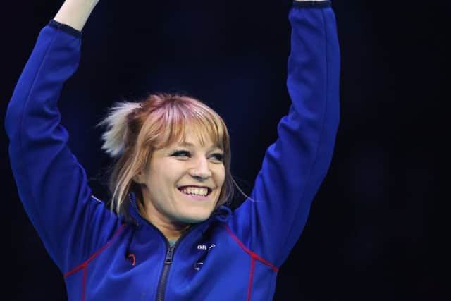 Elise Christie celebrates on the podium after clinching the women's overall title at the World Short Track Championships in Rotterdam. Picture: Dean Mouhtaropoulos/Getty Images