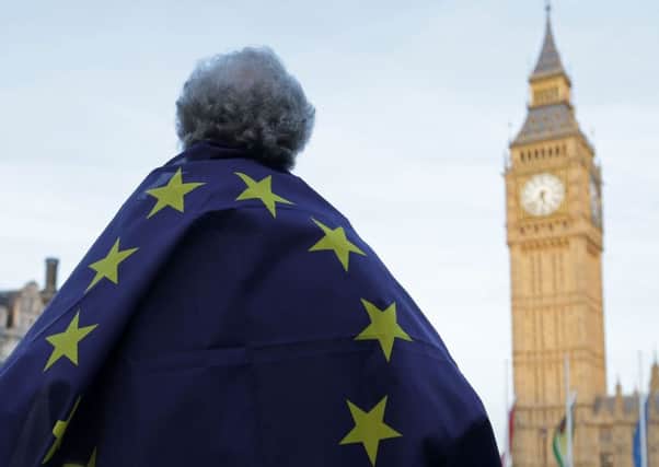 A protester draped in a European Union flag takes part in a protest outside the Houses of Parliament. Picture: Getty