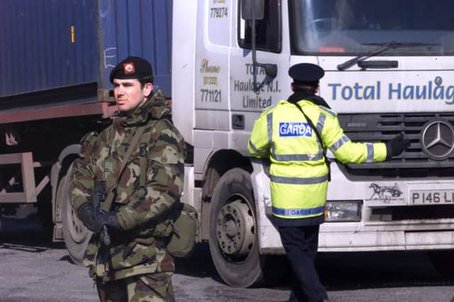 The Irish Army and the Garda (Irish Police) stand near checkpoints on the border with Northern Ireland  in 2001 (AP Photo/Peter Morrison)