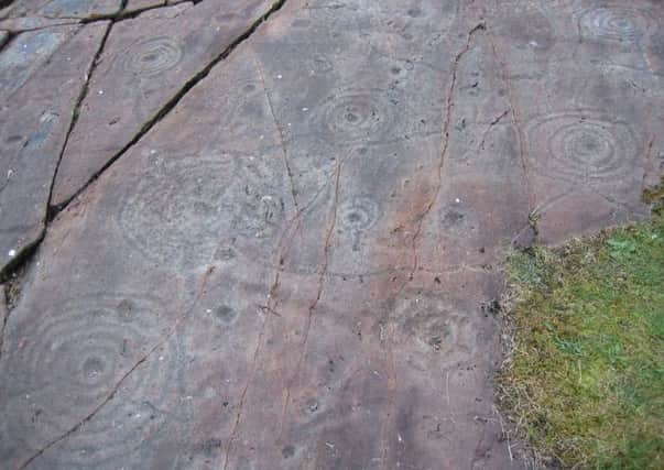 Known as the Achnabreck Cup and Ring Rocks, the mysterious motifs consist of a series of spiral ring marks. Picture: Wikimedia Commons