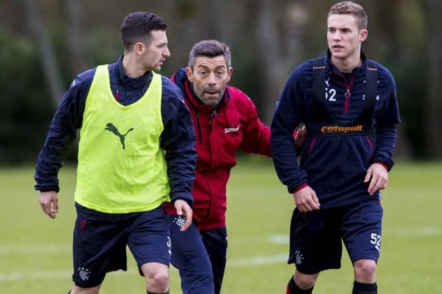 New Rangers manager Pedro Caixinha issues instructions to Jason Holt and Liam Burt, right, during training. Picture: Craig Williamson/SNS