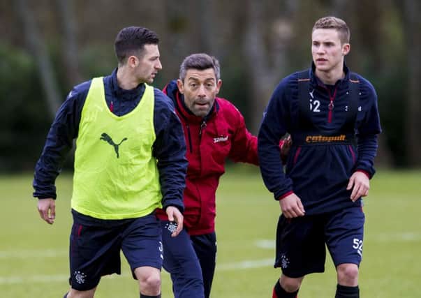 New Rangers manager Pedro Caixinha issues instructions to Jason Holt and Liam Burt, right, during training. Picture: Craig Williamson/SNS
