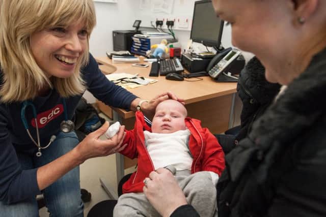 Dr Susan Langridge during a consultation with a baby and her mother. Picture: John Devlin