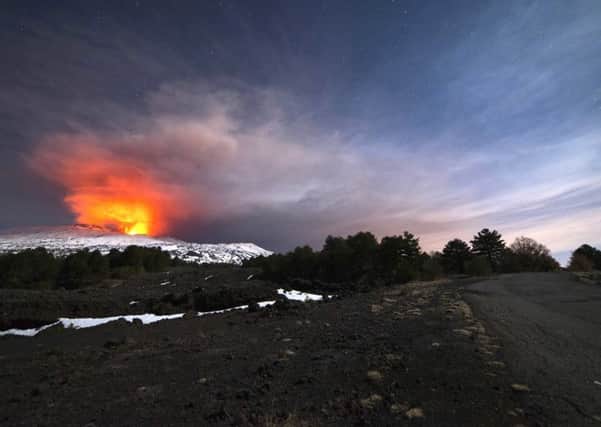 Mount Etna is seen from the side of a road as it spews lava during an eruption in the early hours of March 16. Picture: AP