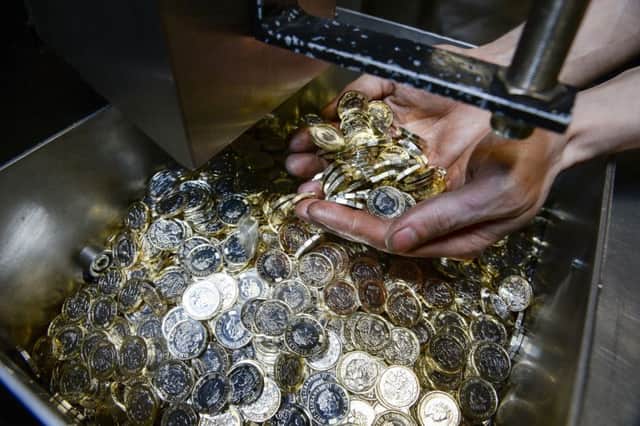 The dodecagon pound coin is thinner and lighter than its round predecessor, but its diameter is slightly larger. Photograph: PA