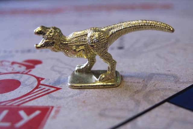 In comes a Tyrannosaurus Rex, out goes the thimble. Picture: AP