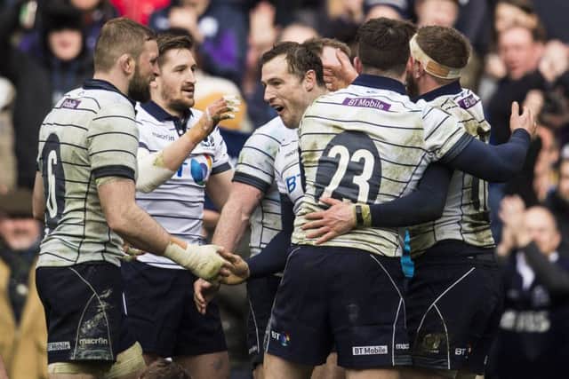 Tim Visser (centre) celebrates his try with team-mates. Picture: SNS Group/SRU Gary Hutchison