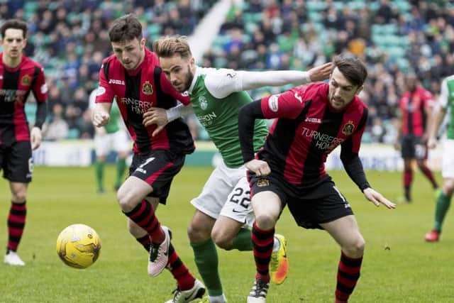 Andrew Shinnie battles for the ball with Dumbarton's Callum Gallagher and David Smith. Picture: SNS/Alan Rennie