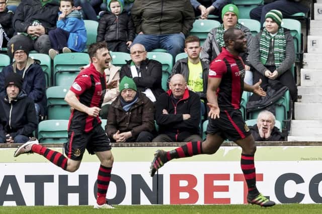Christian Nade celebrates scoring another goal against Hibs. Picture: SNS/Alan Rennie