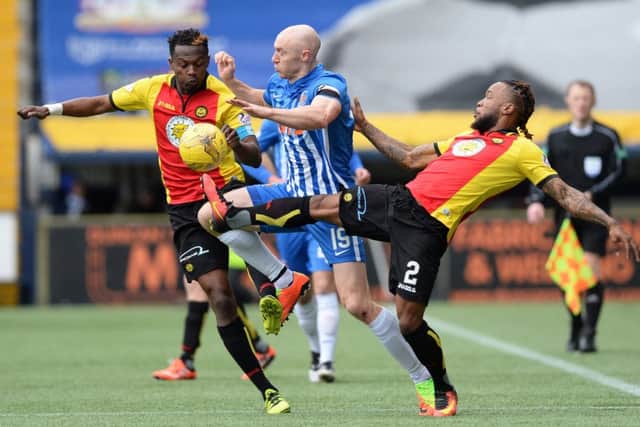 Kilmarnock's Conor Sammon battles with Partick Thistle's Abdul Osman and Mustapha Dumbuya. Picture: SNS/Sammy Turner