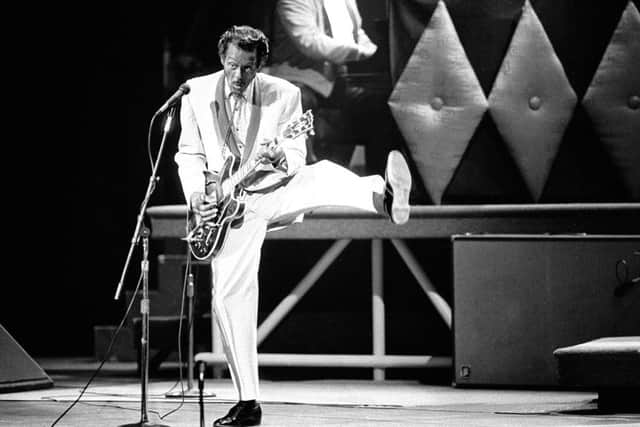 Chuck Berry performs during a concert celebration for his 60th birthday at the Fox Theatre in St. Louis.