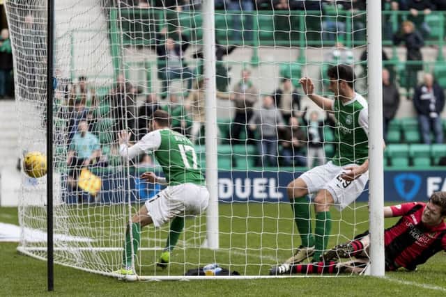 Martyn Boyle follows the ball into the net as his header earns a point for Hibs. Picture: SNS.