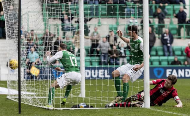 Martyn Boyle follows the ball into the net as his header earns a point for Hibs. Picture: SNS.