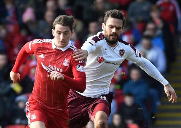 Kenny McLean leaves Alexandros Tziolis in his wake. Picture: SNS.