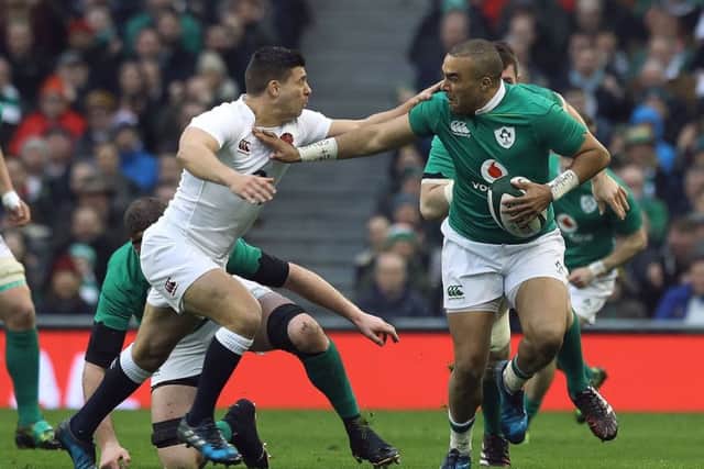 Ireland winger Simon Zebo fends off England scrum-half Ben Youngs. Picture: PA.