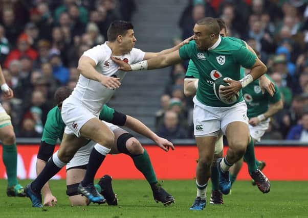 Ireland winger Simon Zebo fends off England scrum-half Ben Youngs. Picture: PA.