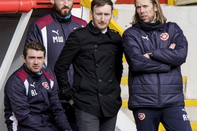 Hearts director of football Craig Levein passed messages to head coach Ian Cathro, centre, at Pittodrie. Picture: SNS.
