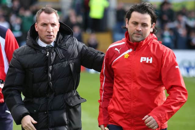 Dundee boss Paul Hartley, right, could give Brendan Rodgers and Celtic the title a few days earlier than planned. Pic: SNS