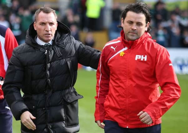 Dundee boss Paul Hartley, right, could give Brendan Rodgers and Celtic the title a few days earlier than planned. Pic: SNS