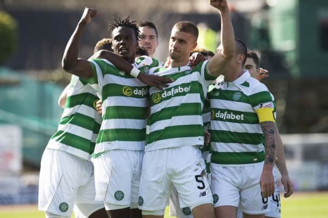Jozo Simunovic, No 5, celebrates with his team-mates after scoring against Dundee on Sunday. Picture: SNS.