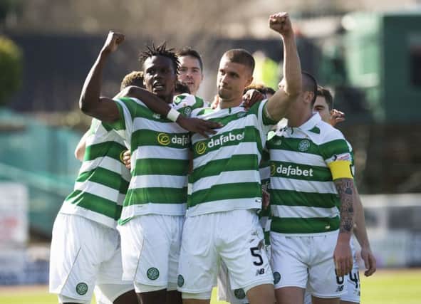 Jozo Simunovic, No 5, celebrates with his team-mates after scoring against Dundee on Sunday. Picture: SNS.