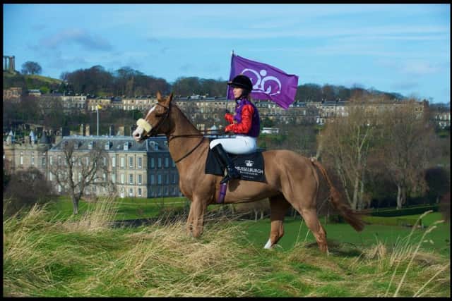 Jockey Kirsty Purves, in the Queen's colours, with the Palace of Holyroodhouse in the background. Picture: robmcdougall.com