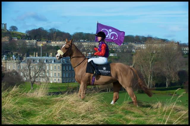 Jockey Kirsty Purves, in the Queen's colours, with the Palace of Holyroodhouse in the background. Picture: robmcdougall.com
