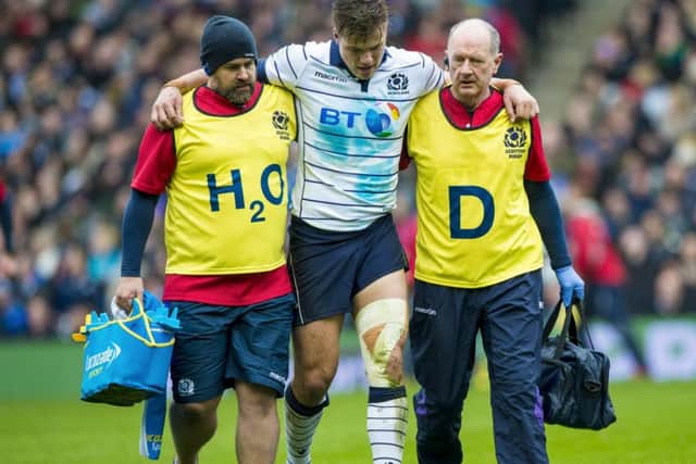 Scotland's Huw Jones goes off with a hamstring injury against Italy. He is out for five months. Picture: Paul Devlin/SNS