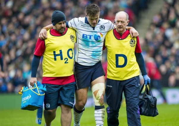 Scotland's Huw Jones goes off with a hamstring injury against Italy. He is out for five months. Picture: Paul Devlin/SNS