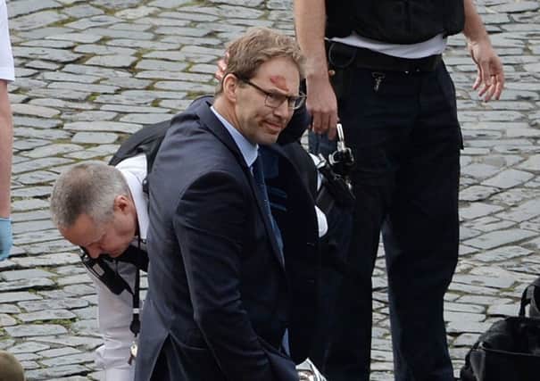 Conservative MP Tobias Ellwood stands amongst the emergency services (Photo: Stefan Rousseau/PA Wire)
