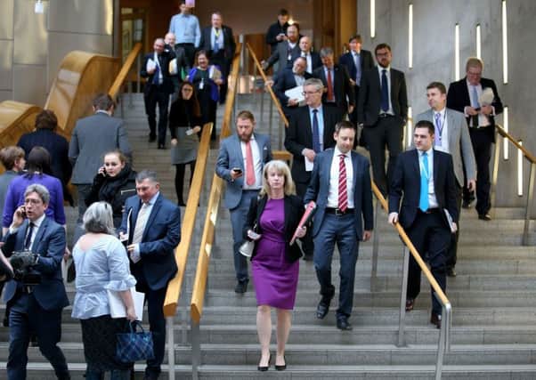 MSPs leave the main chamber at the Scottish Parliament after the session was suspended. Picture: PA