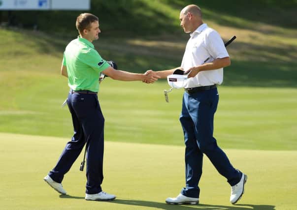 Russell Knox shakes hands with Bill Haas after beating the American 3&2 in Texas. Picture: Getty Images