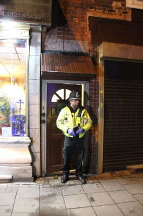 A police officer stand outside an address in Hagley Road, Birmingham, where armed police have raided a flat overnight. (photo: Richard Vernalls/PA Wire)