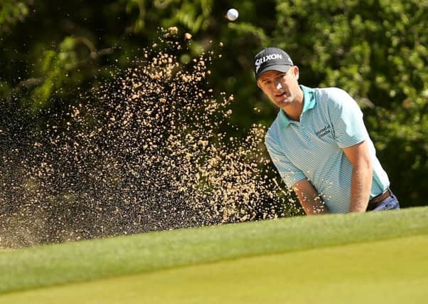 Russell Knox plays out of a bunker at the first hole during the second round of the World Golf Challenge Match Play in Texas.