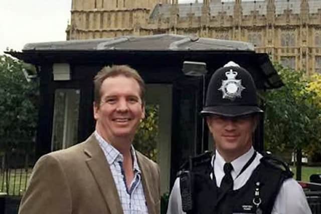 PC Keith Palmer poses for a picture with Andrew Thorogood outside the Houses of Parliament in October 2016. Picture: SWNS
