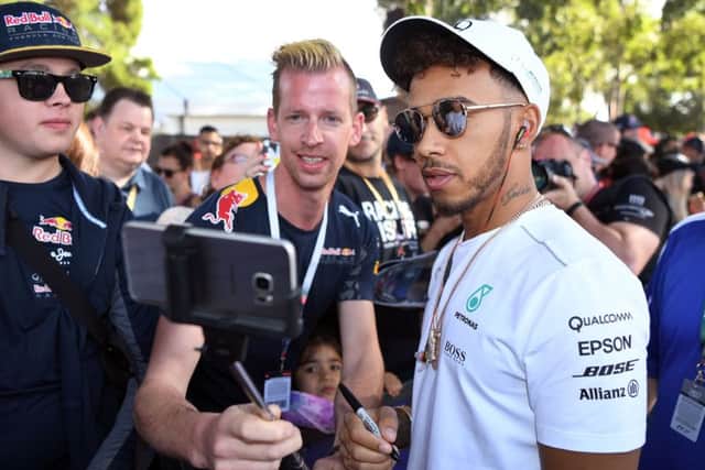 Fans take selfies with Mercedes' Lewis Hamilton who was fastest in practice ahead of the Australian Grand Prix. Picture: William West/AFP/Getty Images