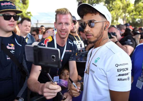 Fans take selfies with Mercedes' Lewis Hamilton who was fastest in practice ahead of the Australian Grand Prix. Picture: William West/AFP/Getty Images