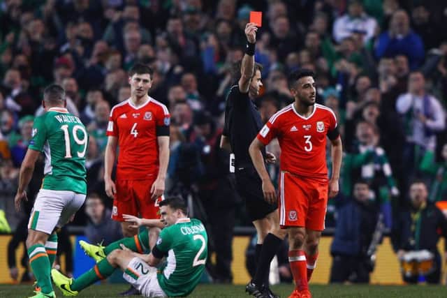 Neil Taylor is dismissed following a horror tackle on Irelands Seamus Coleman, grounded. Picture: Getty.