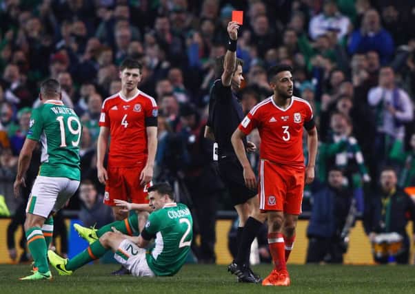 Neil Taylor is dismissed following a horror tackle on Irelands Seamus Coleman, grounded. Picture: Getty.