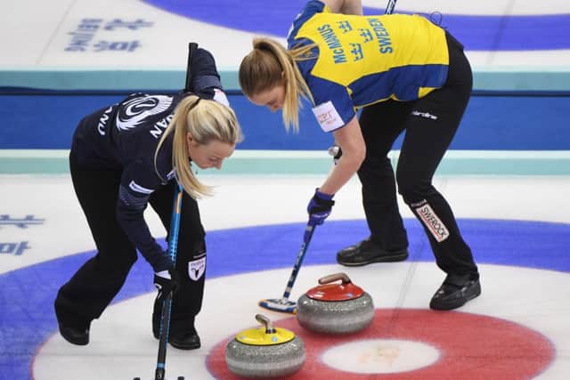 Scotland's Anna Sloan, left, and Sweden's Sara McManus sweep during their play-off at the Women's Curling World Championships. Picture: Getty Images